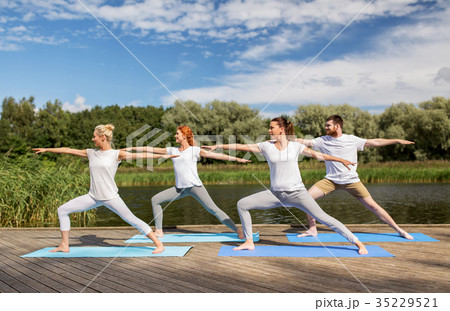 group of people making yoga exercises outdoors 35229521