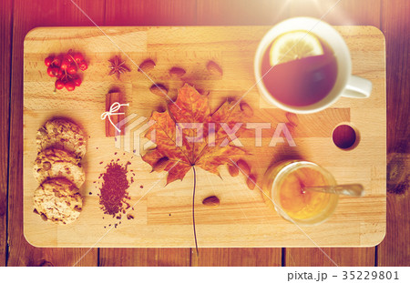 cup of tea with lemon, honey and cookies on board 35229801