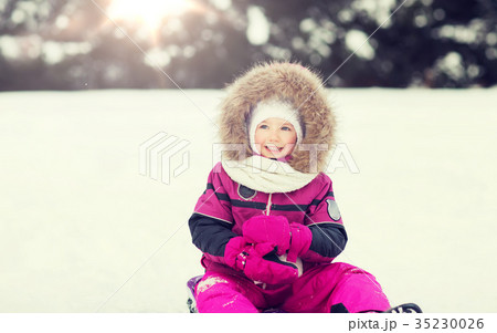 happy little kid on sled outdoors in winter 35230026