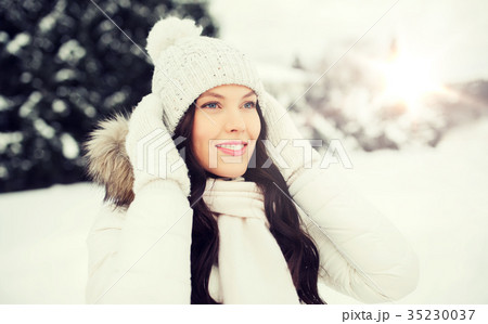 happy woman outdoors in winter clothes 35230037
