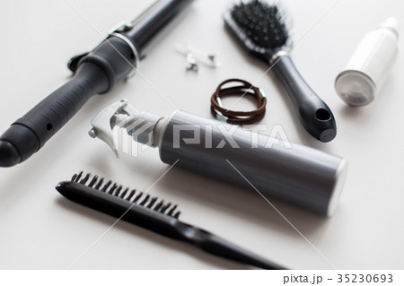 styling spay, brushes, hair ties and curling iron 35230693