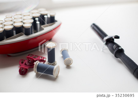 hot rollers kit on table with hair clips and iron 35230695