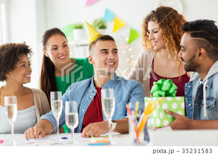 team greeting colleague at office birthday party team greeting colleague at office birthday party 35231583