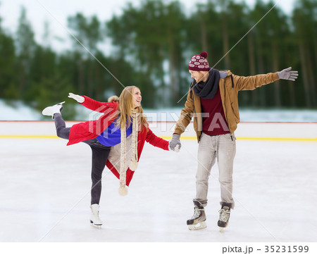 happy couple holding hands on skating rink happy couple holding hands on skating rink 35231599