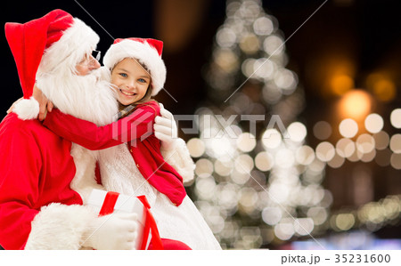 santa claus with happy girl over christmas tree santa claus with happy girl over christmas tree 35231600