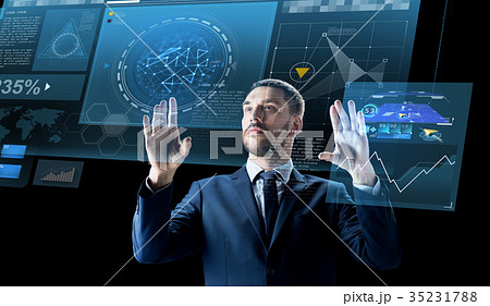 businessman with virtual projection over black 35231788