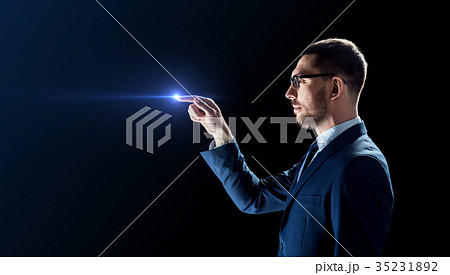 businessman in glasses with laser light over black 35231892