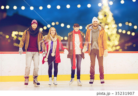 happy friends on christmas skating rink 35231907