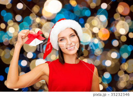 happy woman in santa hat with christmas bells happy woman in santa hat with christmas bells 35232346