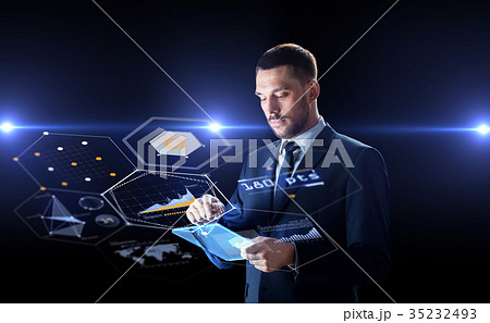 businessman with tablet pc and virtual screens businessman with tablet pc and virtual screens 35232493