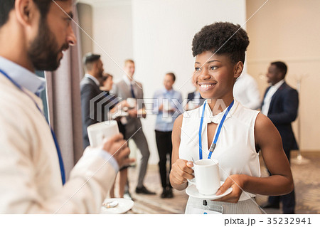business people with conference badges and coffee 35232941