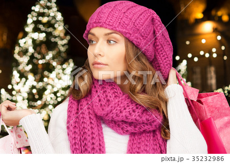 happy woman with shopping bags over christmas tree happy woman with shopping bags over christmas tree 35232986