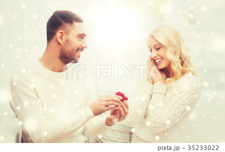 man giving woman engagement ring for christmas man giving woman engagement ring for christmas 35233022