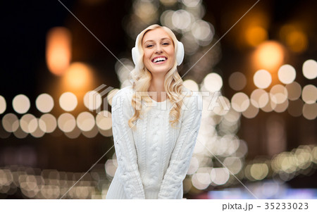 happy woman over christmas lights 35233023