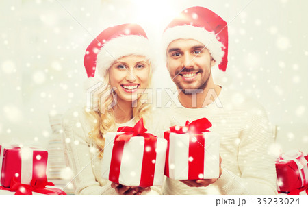 happy couple at home with christmas gift boxes 35233024