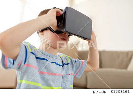 little boy in vr headset or 3d glasses at home little boy in vr headset or 3d glasses at home 35233161