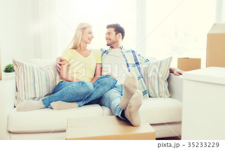 happy couple with big cardboard boxes at new home 35233229