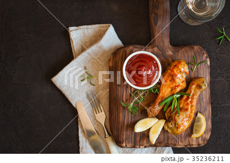 Grilled spicy chicken drumstick is served on board Grilled spicy chicken drumstick is served on board 35236211