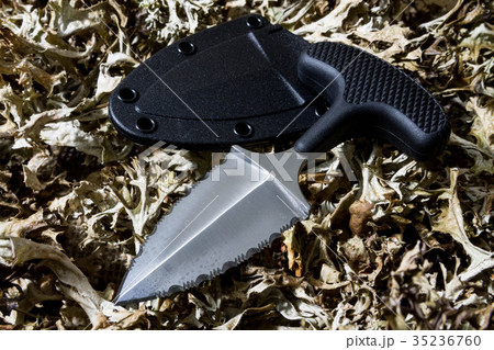 Urban knife on dry grass. Cold temperature. Urban knife on dry grass. Cold temperature. 35236760