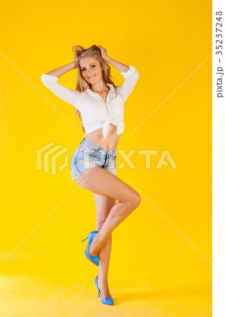 skinny girl posing on a yellow background fashion 35237248