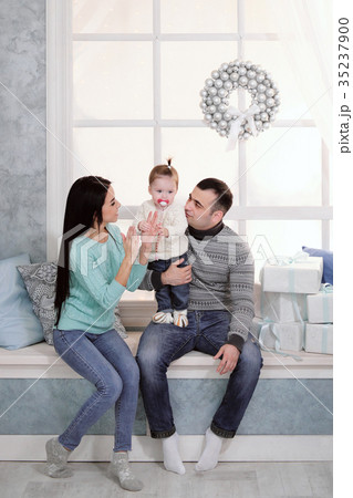 Family mom, dad and daughter at home on the Family mom, dad and daughter at home on the 35237900