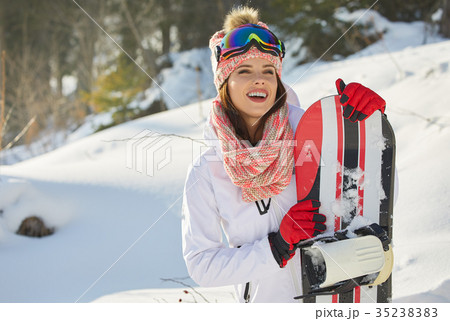 Sexy snowboarder woman outdoors. Winter resort Sexy snowboarder woman outdoors. Winter resort 35238383