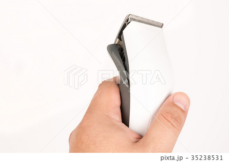 White haircut trimmer in the hand white background White haircut trimmer in the hand white background 35238531
