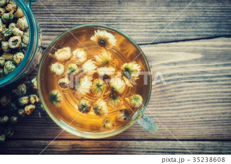Healthy chamomile tea cup and jar of daisy flowers 35238608