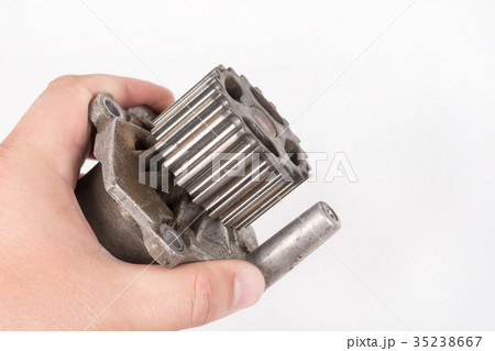 Old car water pump in the hand on white background Old car water pump in the hand on white background 35238667