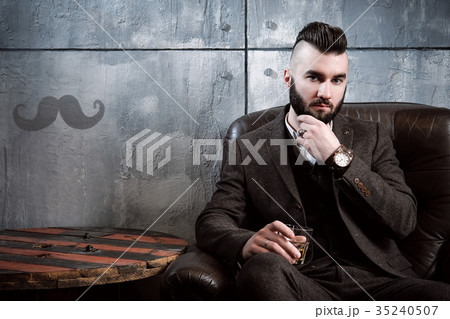 A handsome brutal young stylish brunette man with A handsome brutal young stylish brunette man with 35240507