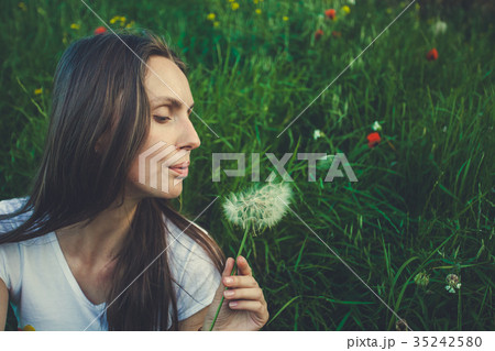 Allergy free concept. Woman blowing dandelion 35242580