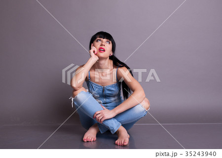 beautiful girl in denim overalls sitting on the 35243940