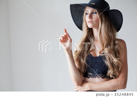 fashionable girl in a hat with a brim poses for fashionable girl in a hat with a brim poses for 35248845