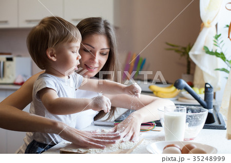 mother and son prepare pie with flour 35248999