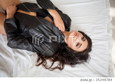 girl in black lingerie is lying on a white bed girl in black lingerie is lying on a white bed 35249784