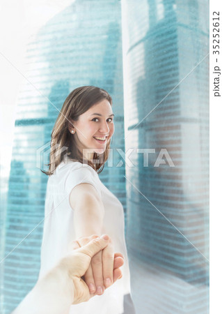 Happy smiling woman holding man hand 35252612