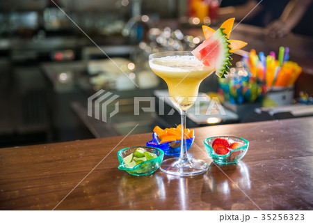 Cocktail drink in yellow favor Cocktail drink in yellow favor 35256323