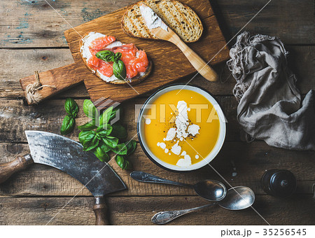 Dinner or lunch with pumpkin cream soup and toasts 35256545