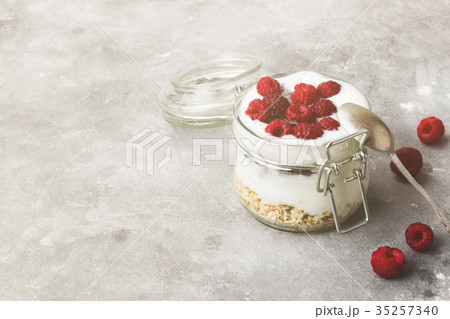 Glanola in glass jar with raspberry Glanola in glass jar with raspberry 35257340