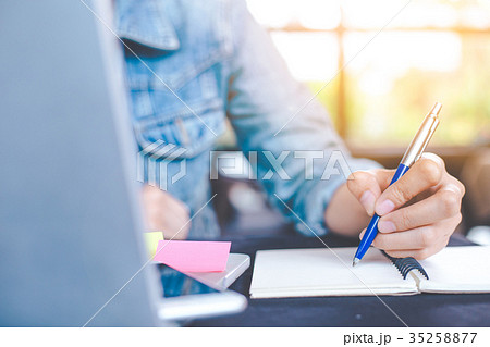 Woman hand works in a laptop computer 35258877
