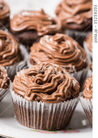 Closeup of chocolate cup cakes with ganache 35259203