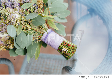 Beautiful wedding bouquet lie on glass table Beautiful wedding bouquet lie on glass table 35259353