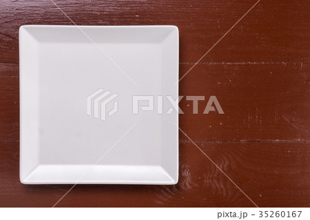 Flat lay above white square plate on the wooden Flat lay above white square plate on the wooden 35260167