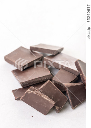 Slices of cooking chocolate on the white marble Slices of cooking chocolate on the white marble 35260657