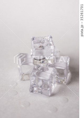 Ice cubes with water drops on the white marble Ice cubes with water drops on the white marble 35261701