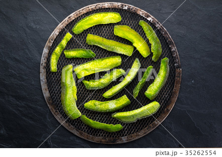 Bright green pieces of pomelo on the grate and on 35262554