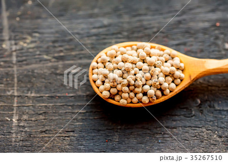 White peppercorn in wooden spoon studio shot 35267510