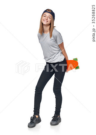 Teen girl in full length walking with skate board Teen girl in full length walking with skate board 35268825