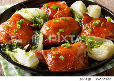 Delicious fried chicken thighs with bok choy 35272422