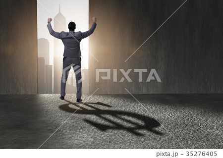 Businessman casting dollar shape shadow in 35276405